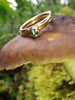 London Blue Topaz and Wound Tiny Gold Stacking Rings balancing precariously on a mushroom
