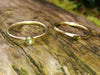 Aquamarine and Wound Tiny Gold Stacking Rings on a log