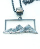 Textured silver mountain landscape pendant on chain