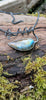 Bud shaped labradorite pendant with a tendril  curling around the oxidised silver spiga chain. With a dreamy elfin it quality sits on a mossy log, the labradorite stone glinting blue and orange in the sunlight.