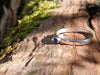 Sterling silver and Blue onyx  stacking ring. Sitting on a mossy log in the sunshine.
