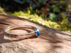 Sterling silver and Turquoise stacking ring. Sitting on a mossy log in the sunshine.