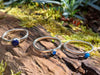 Sterling silver Blue stones stacking ring set. Lapis Turquoise Blue Onyx. Sitting on a mossy log in the sunshine.