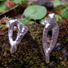 Sterling silver Femscape earrings sitting on a mossy lstone.