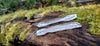 Long melt drop silver earrings on a mossy log in the sunshine.