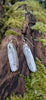 Medium2 melt drop silver earrings on a mossy log