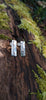 long melt textured silver studs sitting on a mossy log in the sunshine.