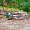 sterling silver 6mm Moss agate stacking ring on a mossy log