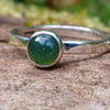 sterling silver 6mm Moss agate stacking ring on a mossy log