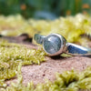 sterling silver 4mm light Moss agate stacking ring on a mossy log