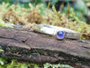 Slim iolite stacker sitting on a mossy log 