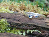 Sterling silver slim stacking ring with a small 3mm round blue flash moonstone