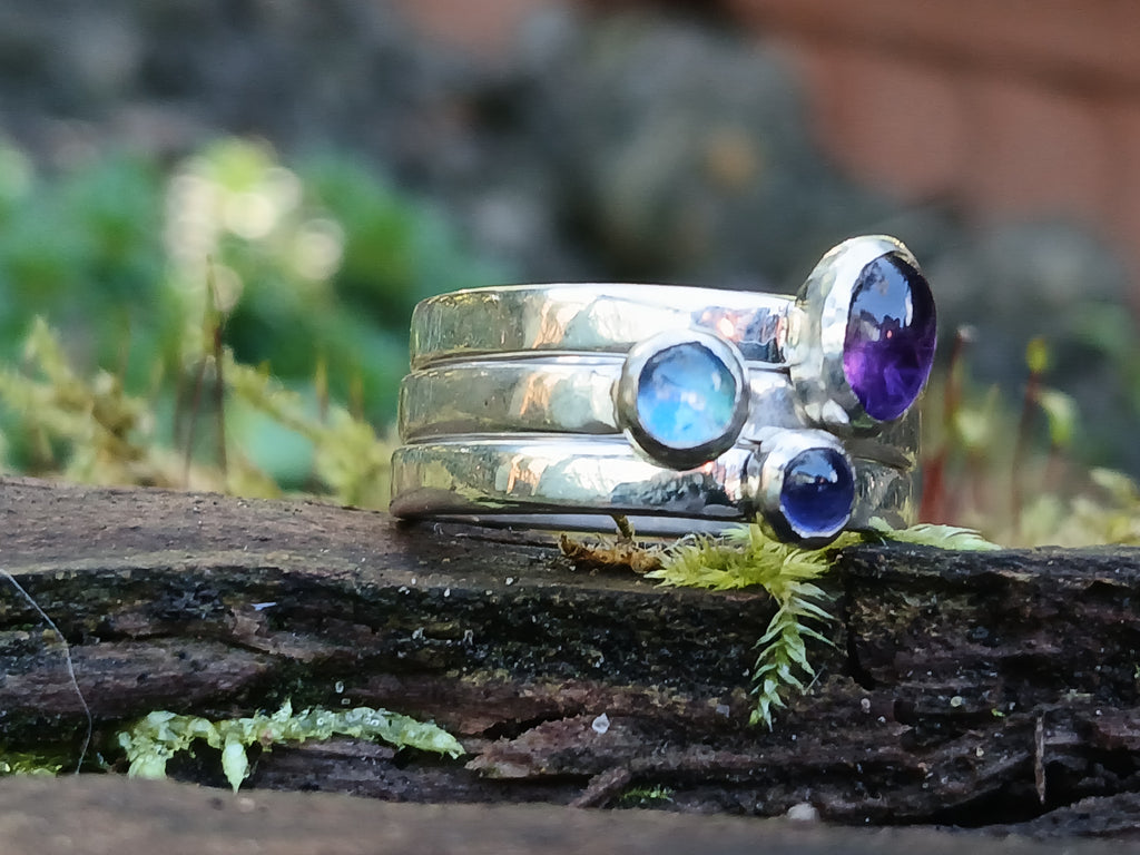 Set of 3 stacking rings sitting on a mossy log