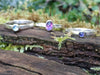 Set of 3 stacking rings sitting on a mossy log