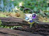 Set of 3 stacking rings sitting on a mossy log