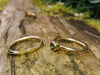 London Blue Topaz and Wound Tiny Gold Stacking Rings sitting on a log in the sunshine
