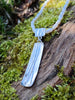 Long melt pendant on slim white pearls pearls