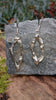 Sterling silver femscape earrings on a piece of slate.