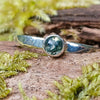 sterling silver 4mm dark Moss agate stacking ring on a mossy log