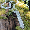Medium Straight sterling silver melt textured pendant on a chunky silver spiga chain. the necklace lies on a mossy woodland log.