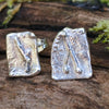 square ish odd melt studs sitting on a mossy log