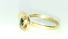Gold cup ring with green stone