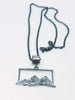 Textured silver mountain landscape pendant on chain