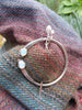 Penannular pin with garnet and opalite